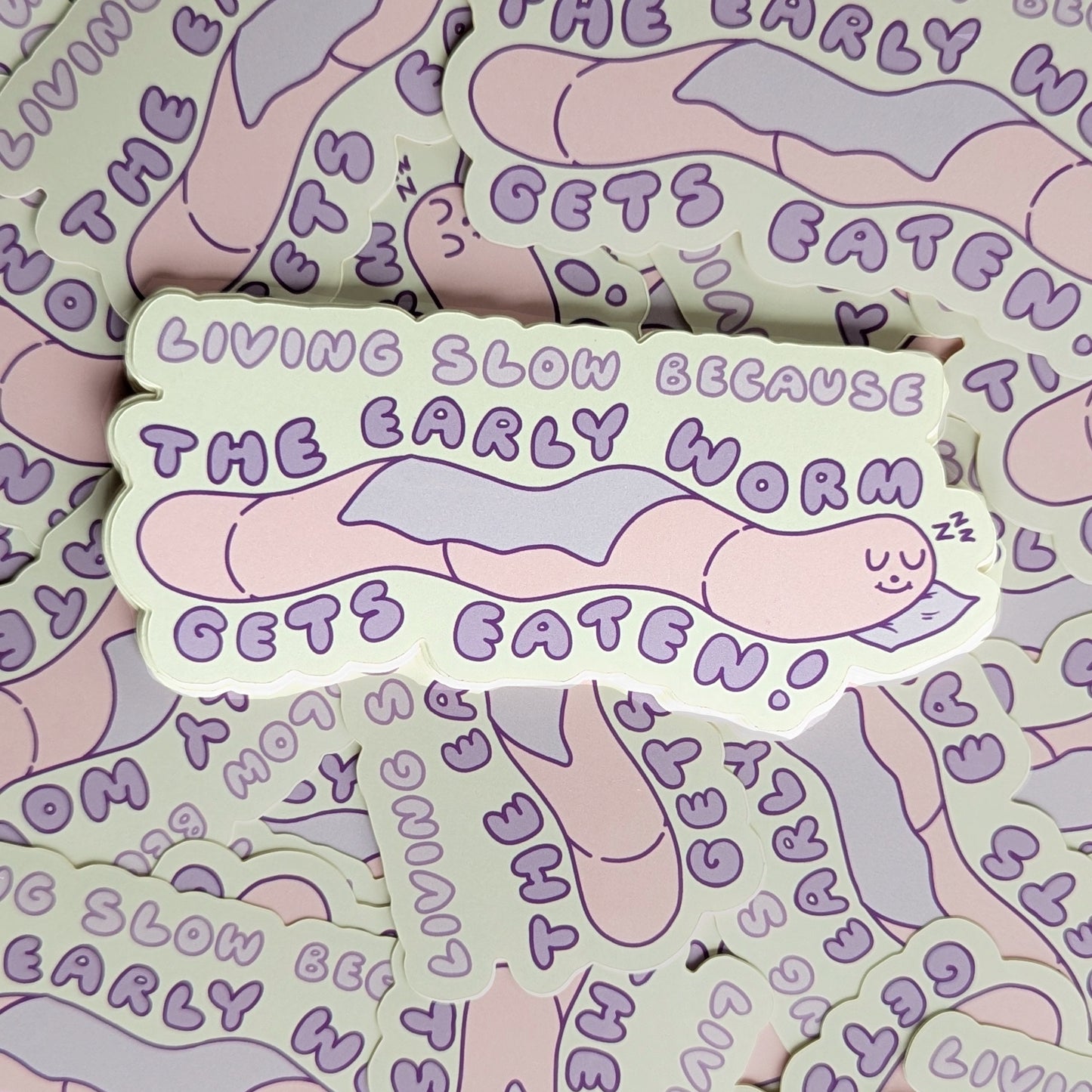 Early Worm Gets Eaten - Meredith Hoagie - Vinyl Stickers Die Cut laying on top of a lot of other stickers