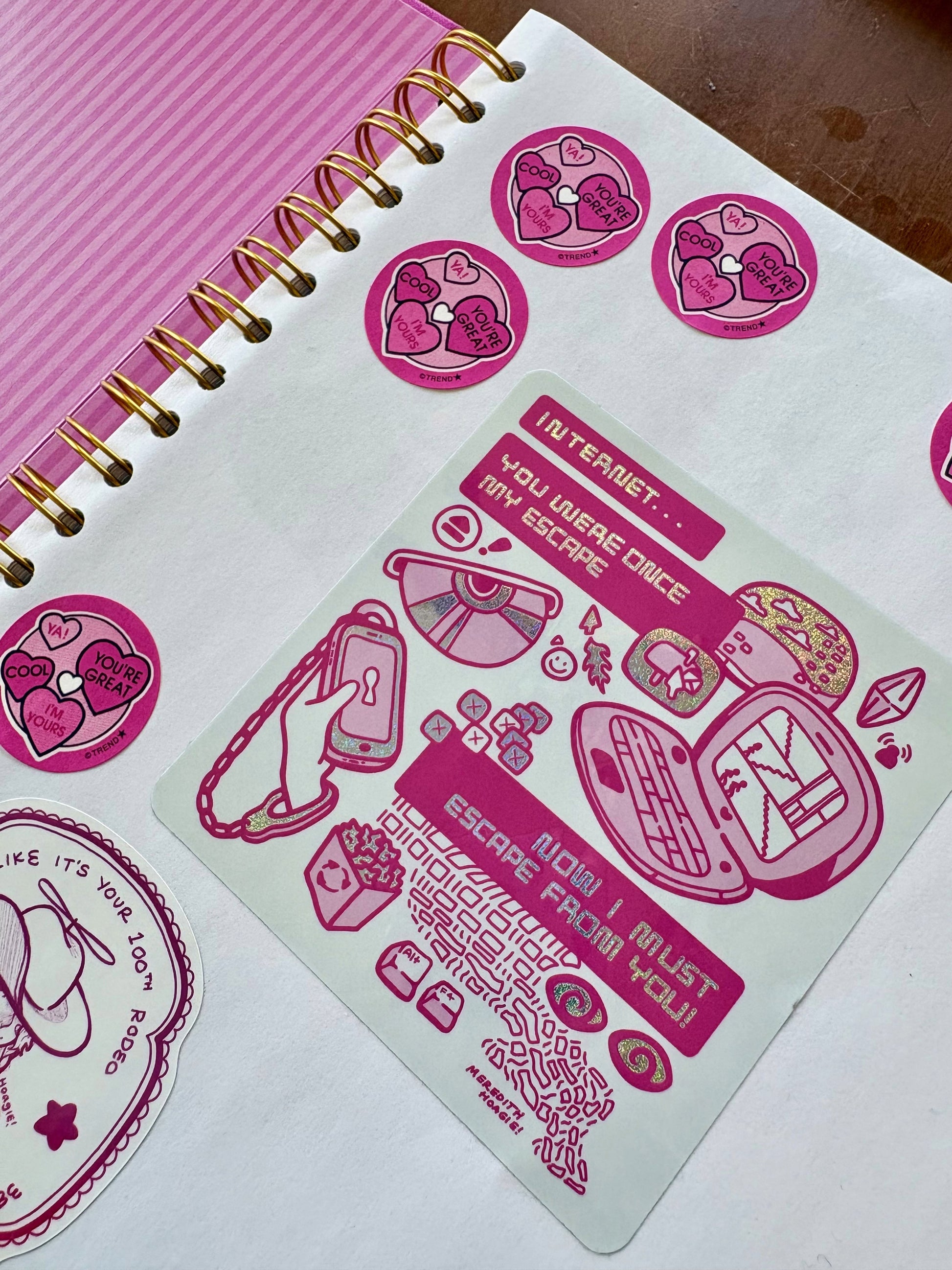 Pink stickers with text and graphics on the Coffee Table Sticker Book by Meredith Hoagie