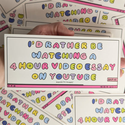 Colorful stickers with text that reads "I'D RATHER BE WATCHING A 4 HOUR VIDEO ESSAY ON YOUTUBE" by Meredith Hoagie held by a hand on top of similar stickers