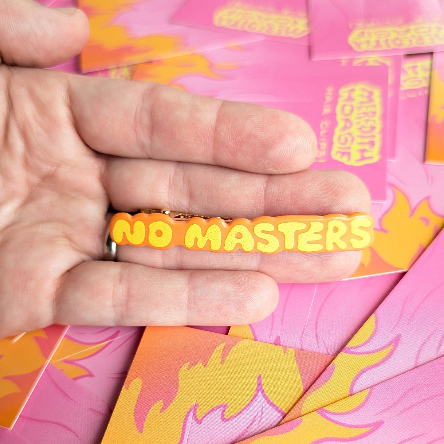 No Gods No Masters No Kings Hair Clips Meredith Hoagie No Masters Size Reference on top of a hand