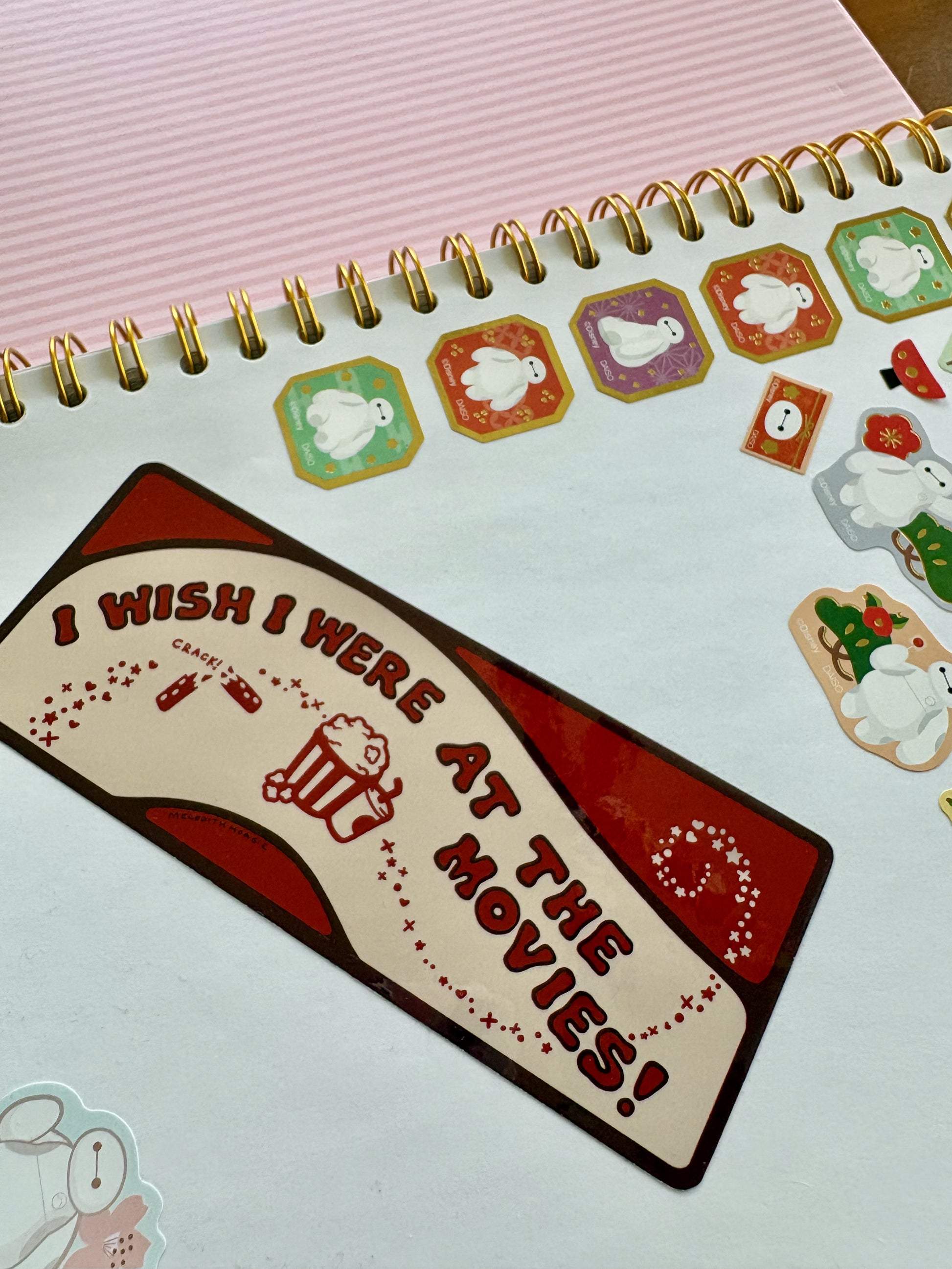 Sticker with 'I Wish I Were at the Movies!' text The Coffee Table Sticker Book notebook with other stickers by Meredith Hoagie and various artists