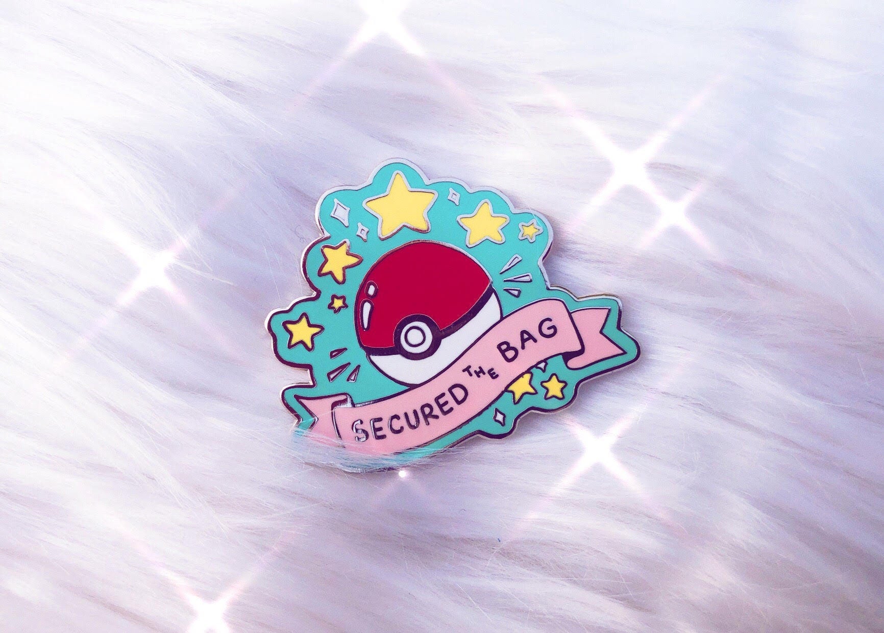 Secured the Bag Pokemon Enamel Pin on a fuzzy white rug
