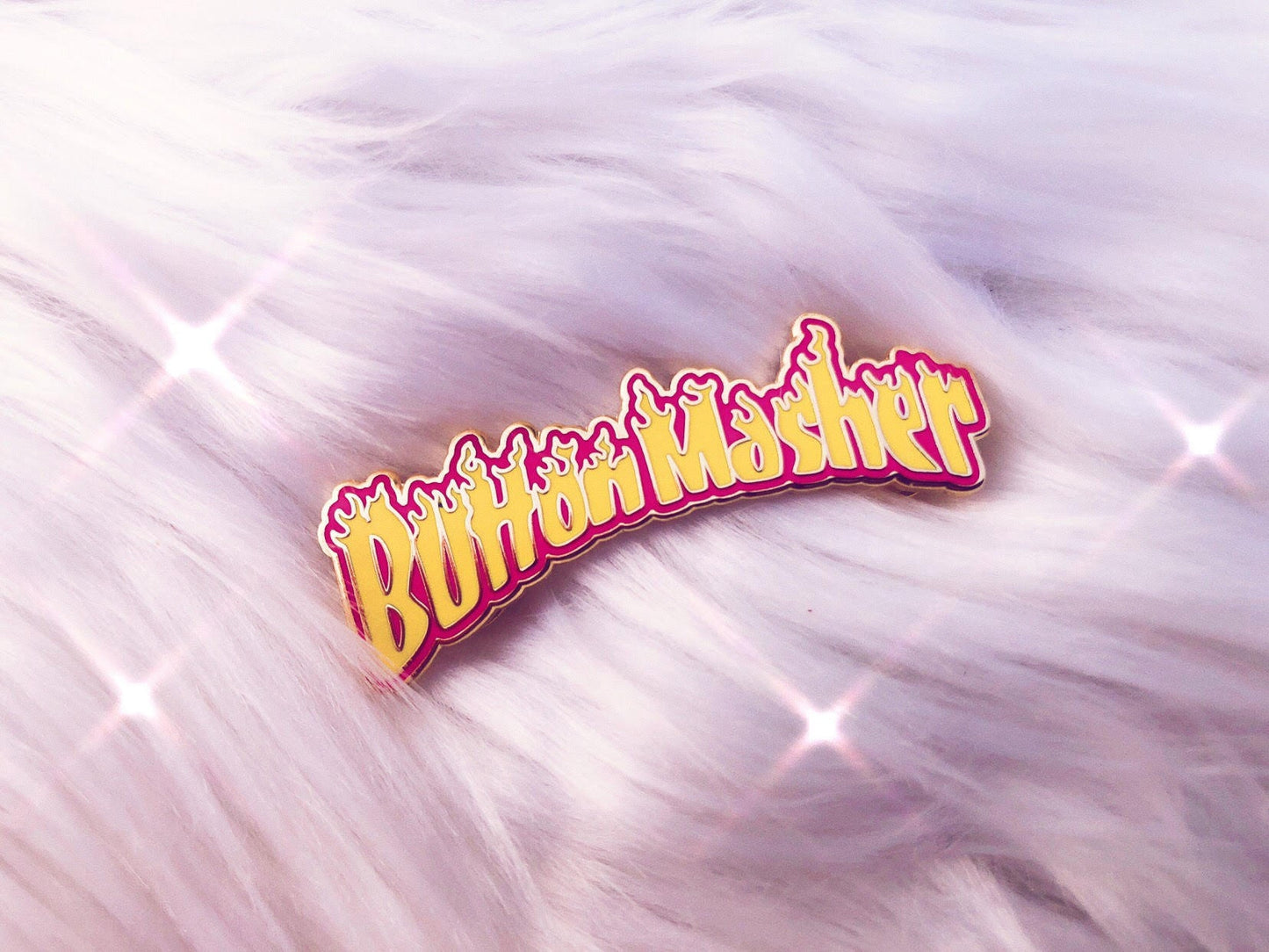 button masher gaming enamel pin on fluffy background