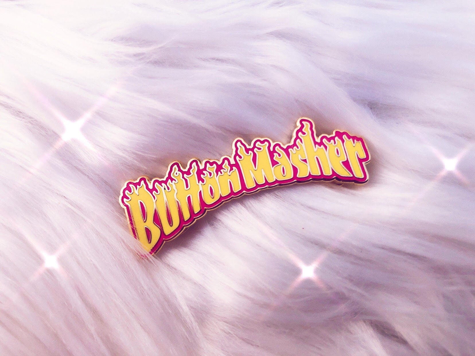 button masher gaming enamel pin on fluffy background