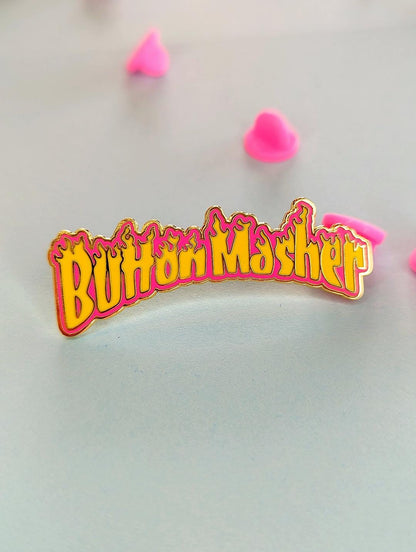 button masher gaming enamel pin on blue background